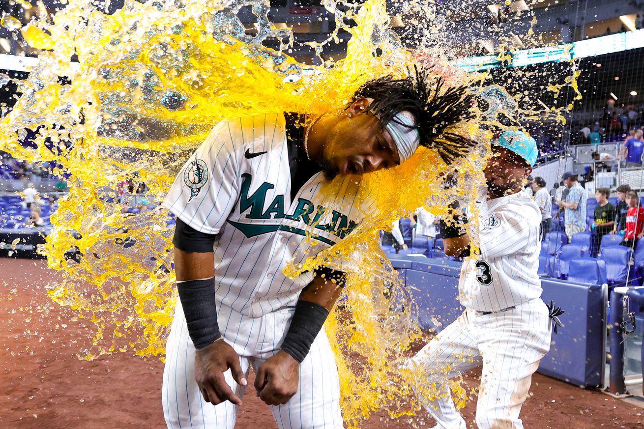 Luis Arraez #3 of the Miami Marlins gives teammate Jean Segura #9 a Gatorade bath after defeating the Chicago Cubs at loanDepot park on April 28, 2023 in Miami, Florida.