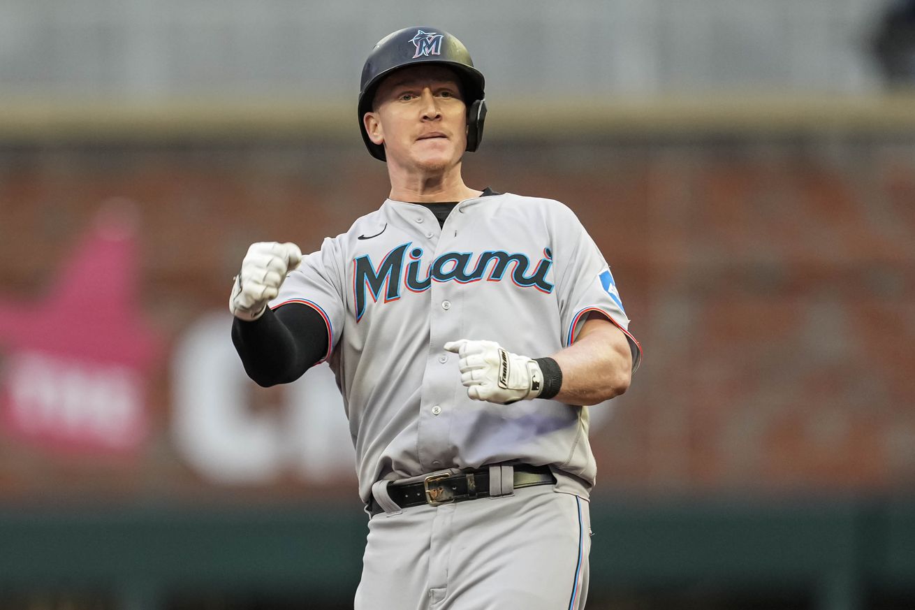 Miami Marlins designated hitter Garrett Cooper (26) reacts after hitting a double and driving in the tying and go ahead runs against the Atlanta Braves during the ninth inning at Truist Park. 