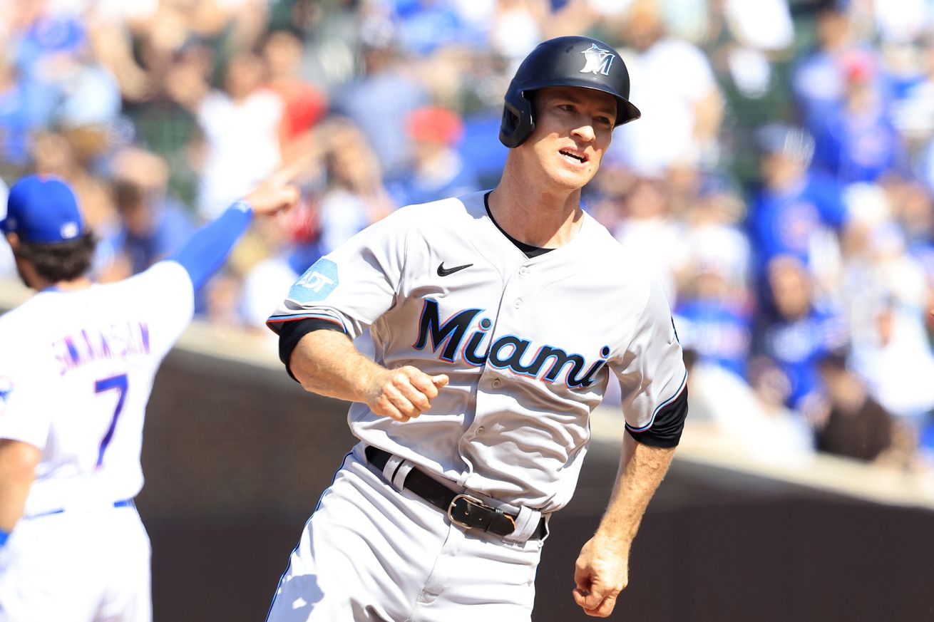 Joey Wendle #18 of the Miami Marlins runs after hitting a triple in the tenth inning against the Chicago Cubs at Wrigley Field on May 07, 2023 in Chicago, Illinois.