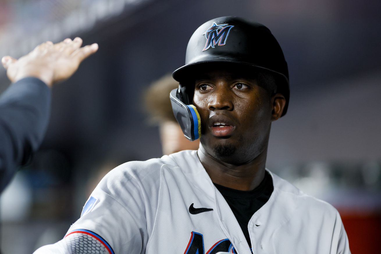 Miami Marlins left fielder Jesus Sanchez (7) looks on from the dugout after scoring during the third inning against the Atlanta Braves at loanDepot Park. 