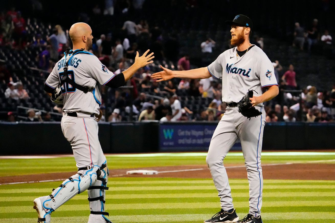 Miami Marlins catcher Jacob Stallings (58) congratulates relief pitcher A.J. Puk (35) after their 5-4 win over the Arizona Diamondbacks at Chase Field.