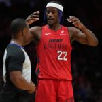 Dec 7, 2024; Miami, Florida, USA; Miami Heat forward Jimmy Butler (22) talks with official Dedric Taylor during a timeout in the second half against the Phoenix Suns at Kaseya Center. Mandatory Credit: Jim Rassol-Imagn Images