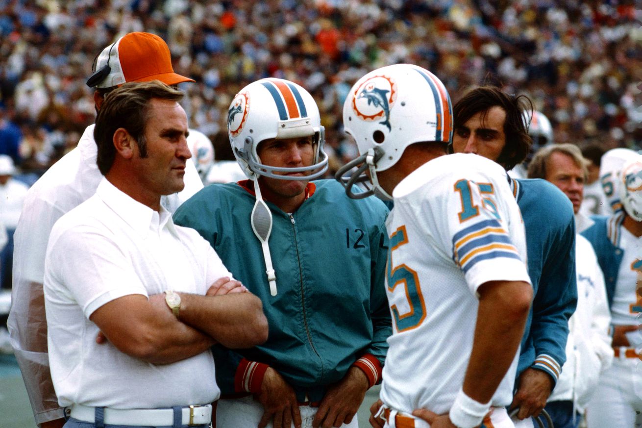 Don Shula, Miami Dolphins Coach, speaks with Quarterback Bob Griese and Quarterback Earl Morrall during an NFL football game against the Baltimore Colts in Miami, Florida, December 16, 1972.